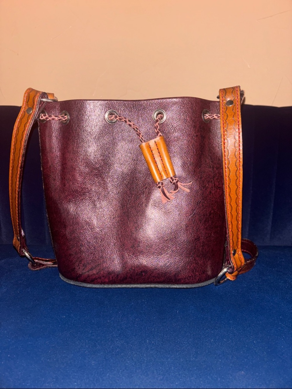 Vintage-Inspired Burgundy Leather Bucket Bag with Tan Accents